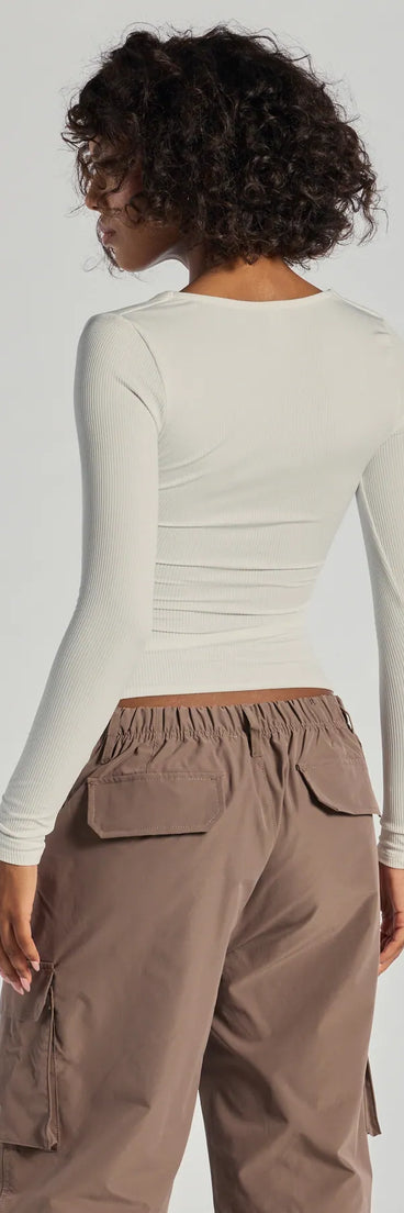 The Forever Staple Smooth Knit Long Sleeve Top is a women's white long-sleeve top with an elevated style and unique design accents, perfect for layering or transitioning into colder months.