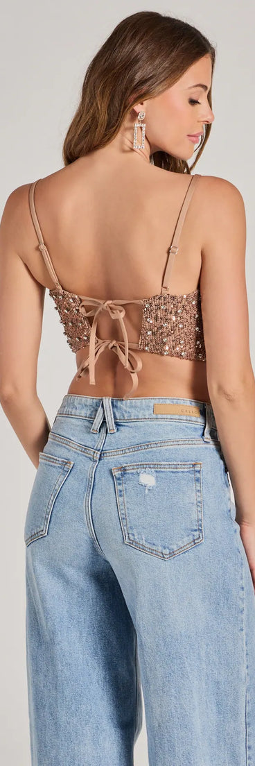 The Glam Of The Moment Rhinestone Sequin Crop Top in copper is a sequin top with an all-over sparkle, perfect for creating a glam concert outfit or adding shimmer to a going-out look. 
