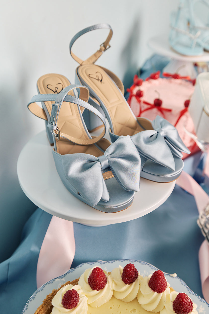 Heel yes—prom shoes with satin & metallic finishes, oversized bows and accents, and feminine details that elevate every step.