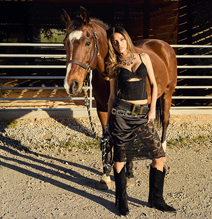 Discover bold cowgirl outfits with corset tops, lace layers, skirts, statement belts, tall boots, and more made for a fresh western vibe.